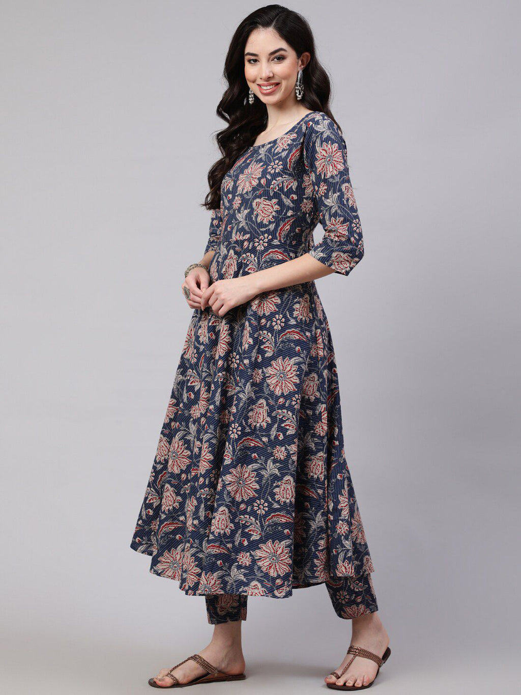 Woman wearing a floral dress on a gray background
