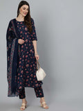 Woman wearing a navy blue floral dress with matching dupatta on a gray background